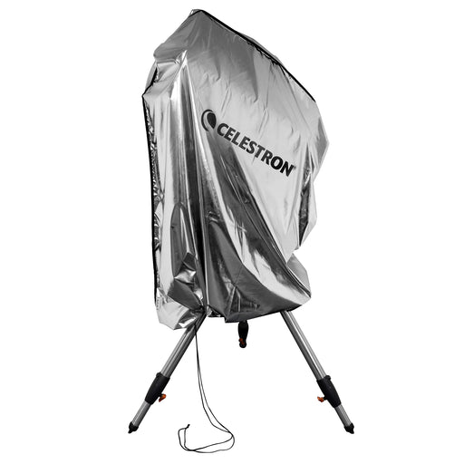 Celestron Weatherproof Telescope Cover draped over a mounted telescope outdoors, showing full-length protection from optical tube to tripod legs.