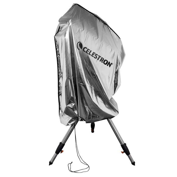 Celestron Weatherproof Telescope Cover draped over a mounted telescope outdoors, showing full-length protection from optical tube to tripod legs.