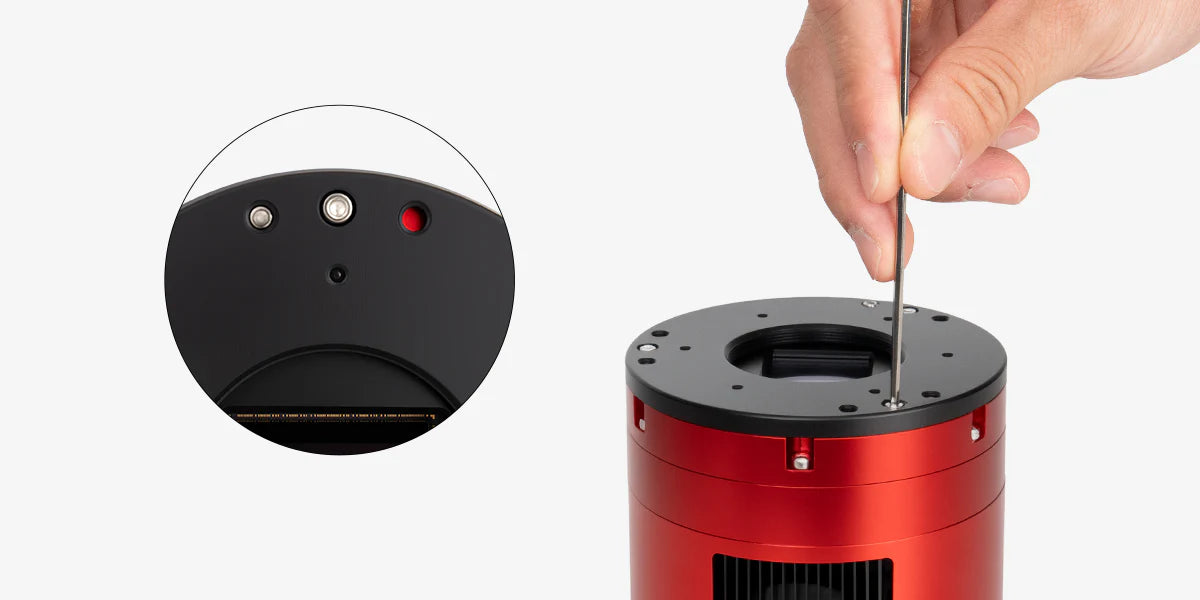 Red mechanical component with a hand using a tool on a white background